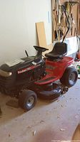 Full side-angle view showing mower front, deck and seat