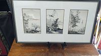Full view of the three-panel framed Chinese watercolor paintings showing entire frame, matting, and artwork.