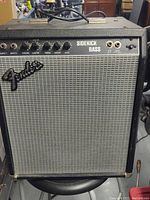 Front view of Fender Sidekick bass amplifier showing control panel, Fender logo, and speaker grille.