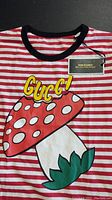 Close-up of the front of the toddler t-shirt showing red and white stripes, a large mushroom graphic with text 'Gucci' and black neckline.