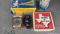 Vintage babushka doll, Forever emergency flashlight in box, light meter, baseball pitch counter, Texas cookie cutter in box