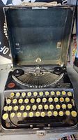 Front view of the Remington Portable typewriter inside its case, showing keys and part of the typing mechanism.