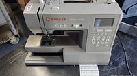Front side view of Singer 6800C Heavy Duty Sewing Machine showing overall machine and control panel.
