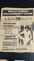 Photo of newspaper titled 'The Sun Reporter' with headline 'Bullet in Head Kills Robbery Victim' and photo of Josephine Baker