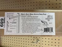 Close-up photo of the instructional label showing heavy duty real estate sign post components and installation instructions.