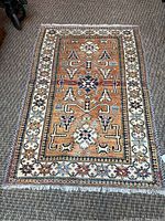 Full view of rug laid flat on floor showing overall design and color palette