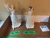 Two Royal Doulton figurines placed side by side showing overall appearance and sizes with model numbers labeled.