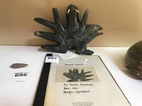 Front view of soapstone carving with accompanying booklet and label.