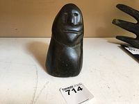 Front view of the Inuit soapstone Eskimo man carving showing the facial features and rounded form.