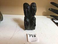 Front view of soapstone carving showing two faces and overall form.