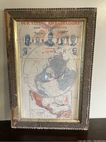 Overall view of the framed vintage aviation map with visible wear and a patterned wooden frame.