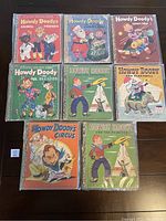 Front covers of eight Howdy Doody Little Golden Books arranged in two rows on a dark surface, colorful vintage illustrated children's books from the 1950s.