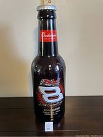 Front view of large glass Budweiser Dale Earnhardt Jr. NASCAR bottle showing branding and label details.