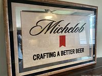 Large Michelob beer sign mirror in wooden frame with visible wear and holes in the frame, glass clear and reflective