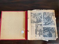 Open scrapbook showing yellowed, worn newspaper clippings about Martin Luther King Jr. in Alabama with images and text.