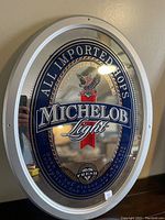 Front view of the oval Michelob Light beer mirror sign showing the logo and design clearly.