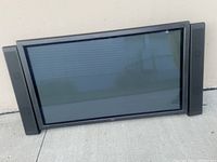 Front view of the NEC 42 inch plasma monitor with speakers on each side, showing the screen and black frame.
