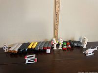 Full lot overview showing train cars, crossing markers, helicopter, and figure lined up on a table.