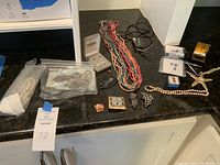 Overview of assorted jewelry items laid out on countertop