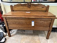 Front view of chest showing carved crest and closed hinged lid