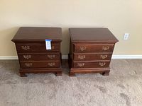 Pair of cherry wood nightstands side by side showing overall shape and size.