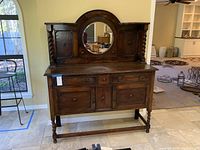 Full front view of sideboard showing raised back, mirror, twist columns, drawer and doors