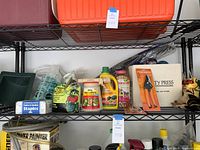 Shelves with multiple gardening items including plant foods, insect spray, fabric and garden staples, and pruners