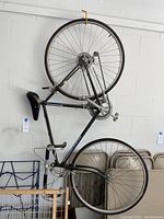 Full side view of Schwinn bicycle hung vertically showing frame, tires, seat, and pedals