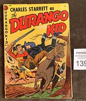 Front cover of 'Charles Starrett as The Durango Kid' comic book No. 25 showing a western action scene with the hero on a horse and a man being tossed off.
