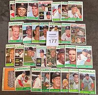 Photo showing 30 vintage 1964 St. Louis Cardinals baseball cards arranged in rows including key players and leader cards.