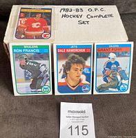 Box labeled '1982-83 O.P.C. Hockey Complete Set' with sample cards (Rejean Lemelin, Ron Francis, Dale Hawerchuk, Grant Fuhr)