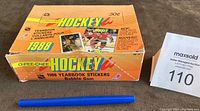 Closed wax box of 1988 O-Pee-Chee OPC Hockey stickers with pen for scale