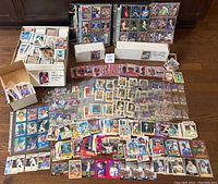 Wide view of thousands of assorted baseball cards including loose cards, cards in binders, and boxed sets.