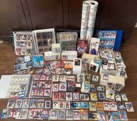 Full view of the large collection displayed on floor including binders, boxes, pages, singles and packs.