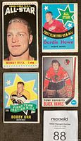 Close-up image of four cards showing Bobby Hull 1963-64 NHL All-Star, Gordie Howe 1968-69 First Team NHL All-Star, Bobby Orr 1967-68 First Team NHL All-Star, Tony Esposito Black Hawks card