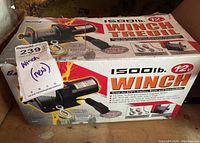 Photo of the box showing branding, capacity, and features of the winch.