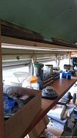Photo of countertop with boxes and containers of assorted screws, nuts, bolts, and small hardware pieces near window