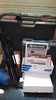 King Canada floor nailer, carrying case, box with manuals and accessory items including King Canada kit and Campbell Hausfeld manual