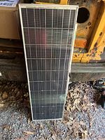 Front view of a Coleman-branded solar panel showing solar cells within an aluminum frame.