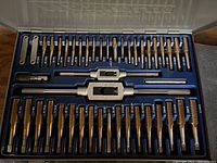 Mastercraft Maximum tap set organized in blue plastic case with multiple taps and two tap handles