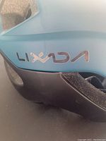 Close-up of the Lixada brand logo on the side of the blue bike helmet.
