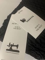 Close-up photo of the Oudota brand tags attached to the leggings, showing branding and quality claims