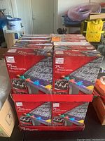 Photo showing 24 boxes of Home Accents Holiday all-purpose light clips, each box containing 75 clips.