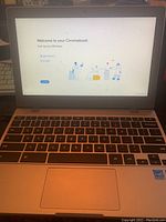 Open Samsung Chromebook showing keyboard and screen with Chromebook welcome setup.