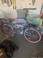 Side profile of the vintage blue Huffy Panama Jack bicycle showing all components including the saddle, tires, frame, and rear rack.