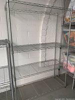 Four-tier 55in wire metal storage rack in a garage or storage area with open wire shelves and metal legs.