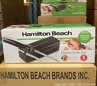 Front view of boxed Hamilton Beach electric knife set showing product image and branding.