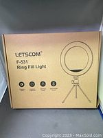 Outer packaging box of Letscom F-531 ring fill light showing product name and feature icons for 3 lighting colors, adjustable brightness, USB power supply, and selfie remote control.