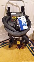 Craftsman 366 60 litre shop vacuum cleaner with hose and wiring visible, showing label and model.