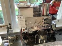 Front view showing Desiderio espresso machine, control panel, steam wand, drip tray, portafilter holder and adjacent coffee grinder